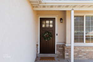 Property entrance with stucco siding and stone siding