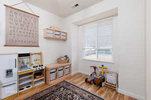 Playroom with light wood-type flooring and baseboards
