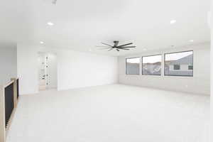 Unfurnished living room with light carpet, recessed lighting, and a ceiling fan