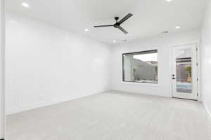 Unfurnished room with light colored carpet, a ceiling fan, and recessed lighting