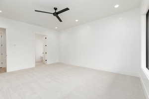 Unfurnished bedroom with light colored carpet, recessed lighting, and ceiling fan
