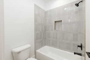 Bathroom featuring toilet and shower / bathtub combination
