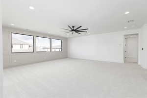 Unfurnished room with light colored carpet, ceiling fan, and recessed lighting