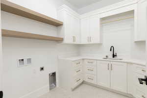 Laundry area featuring washer hookup, hookup for an electric dryer, and cabinet space