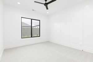 Unfurnished room featuring light colored carpet, recessed lighting, a ceiling fan, and a decorative wall
