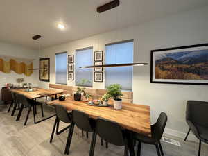 Dining space with a textured ceiling and light wood-style flooring