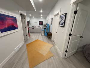 Corridor featuring light wood-style floors