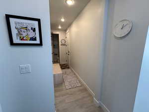 Hall featuring baseboards and recessed lighting