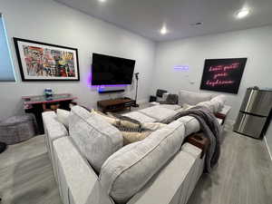 Living room with wood finished floors, recessed lighting, and a textured ceiling
