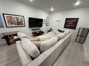 Living room with light wood finished floors and recessed lighting