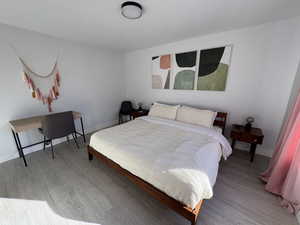 Bedroom featuring light wood-style floors and baseboards