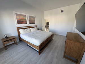 Bedroom with light wood-style floors and baseboards