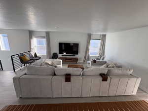 Living room with a textured ceiling and wood finished floors