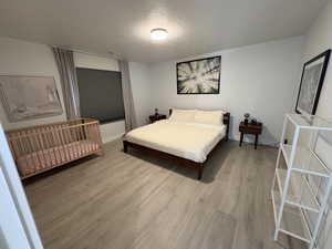Bedroom featuring a textured ceiling and light wood-type flooring