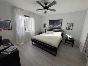 Bedroom with wood finished floors and a ceiling fan