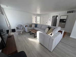 Living room featuring light wood-type flooring and baseboards