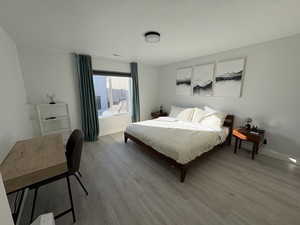 Bedroom with a textured ceiling and wood finished floors