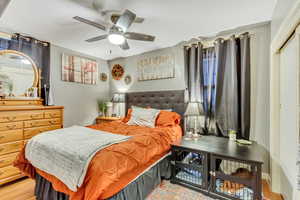 Bedroom featuring wood finished floors and ceiling fan