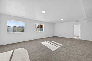 Unfurnished room featuring baseboards and carpet flooring