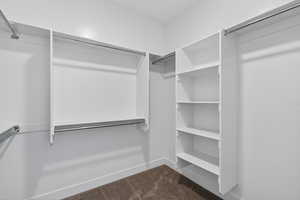 Walk in closet with dark carpet
