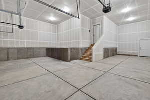 Garage featuring a garage door opener