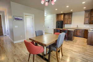 Dining space featuring light wood-type flooring and recessed lighting