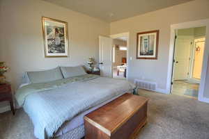 Carpeted bedroom featuring baseboards