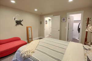 Carpeted bedroom with recessed lighting and baseboards