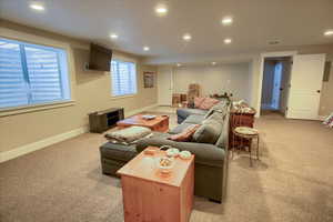 Living room with light colored carpet and recessed lighting