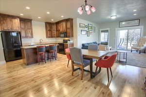 Dining room featuring recessed lighting, a chandelier, and light wood-type flooring