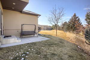 View of green lawn with a patio