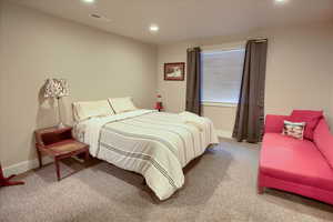 Carpeted bedroom with recessed lighting and baseboards