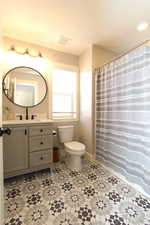 Full bathroom with a shower with curtain and vanity
