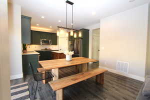 Dining space featuring recessed lighting and dark wood-style floors