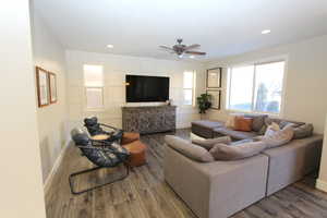 Living room featuring ceiling fan, dark wood-type flooring, and recessed lighting