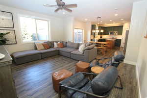 Living area featuring dark wood-type flooring, recessed lighting, and ceiling fan