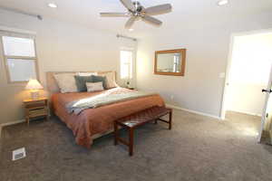 Carpeted bedroom with recessed lighting and ceiling fan
