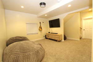Living area featuring stairway, carpet flooring, and recessed lighting