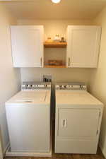 Laundry area featuring washer and dryer and cabinet space