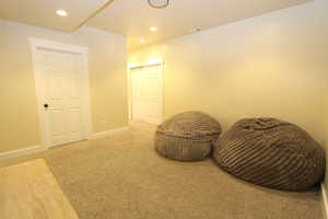 Sitting room with carpet floors and recessed lighting