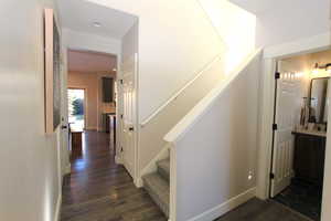 Stairs featuring wood finished floors and recessed lighting