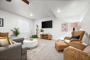Carpeted family room with a ceiling fan and recessed lighting