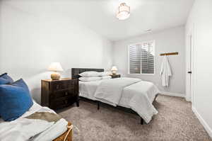 Carpeted bedroom featuring baseboards