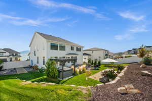 Rear view of property featuring a fenced backyard, a patio area, and a residential view