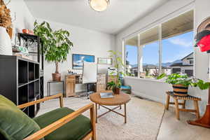 Office space with wood finished floors and a residential view