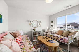 Living room featuring a textured ceiling and a mountain view