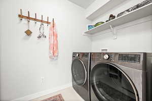Laundry room featuring baseboards and separate washer and dryer