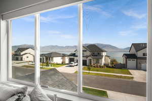 Sunroom with a residential view, a mountain view, and healthy amount of natural light