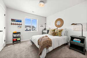Bedroom with carpet floors and baseboards