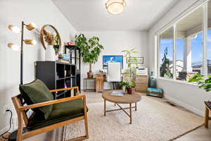 Living area featuring wood finished floors and an office area